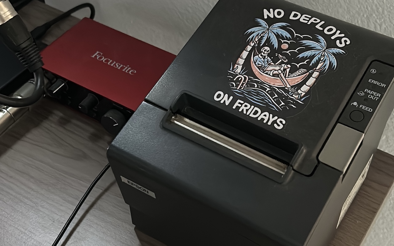 a photo of a receipt printer with a no deploys on fridays sticker